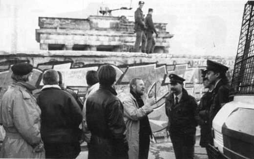 1989: Hermann Lutz (m.) spricht mit der Besatzung eines Einsatzwagens an der Mauer vor dem Brandenburger Tor kurz nach der Grenzöffnung | © DP